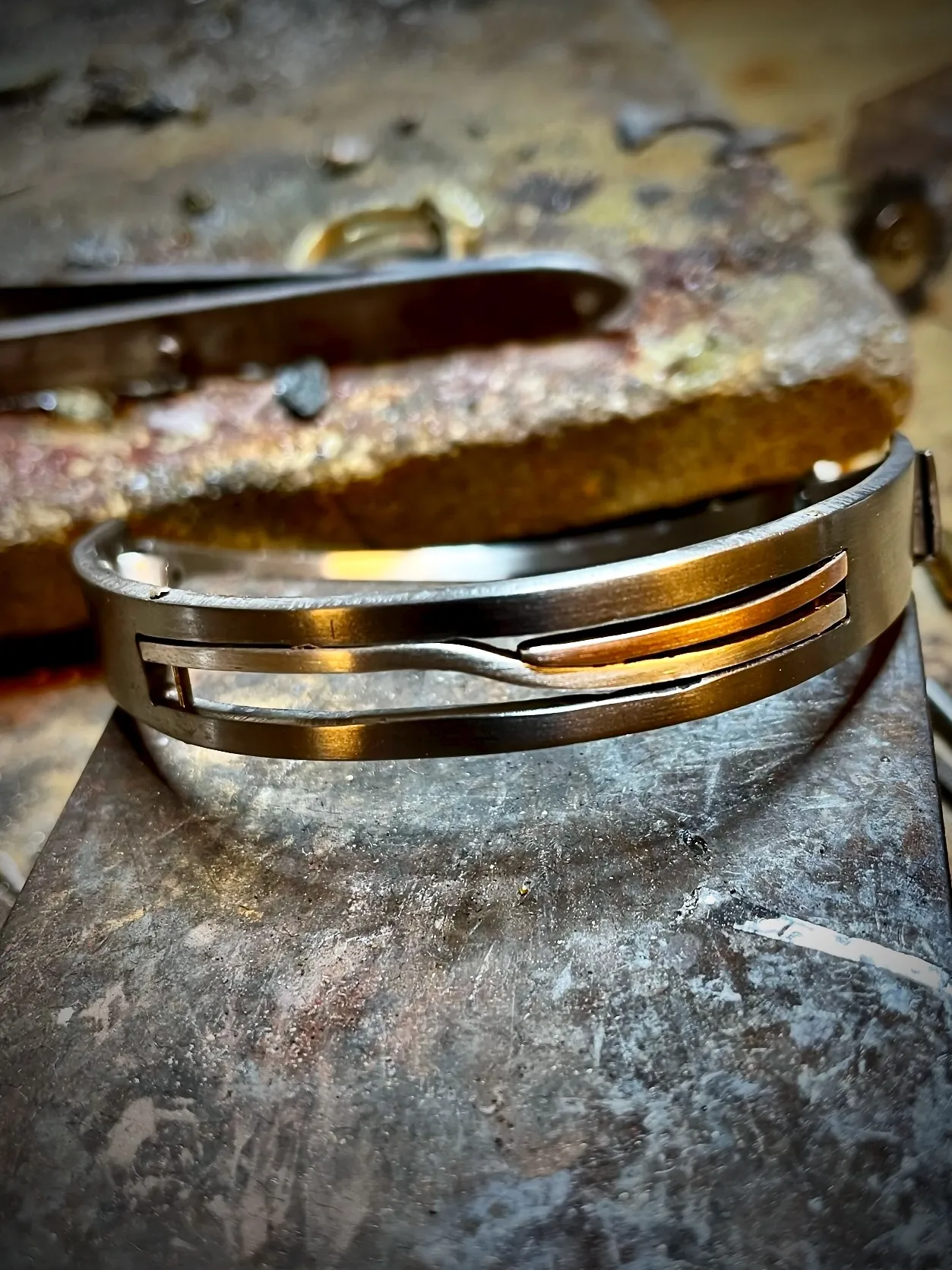 Brede titanium armband met witgouden en roodgouden strepen